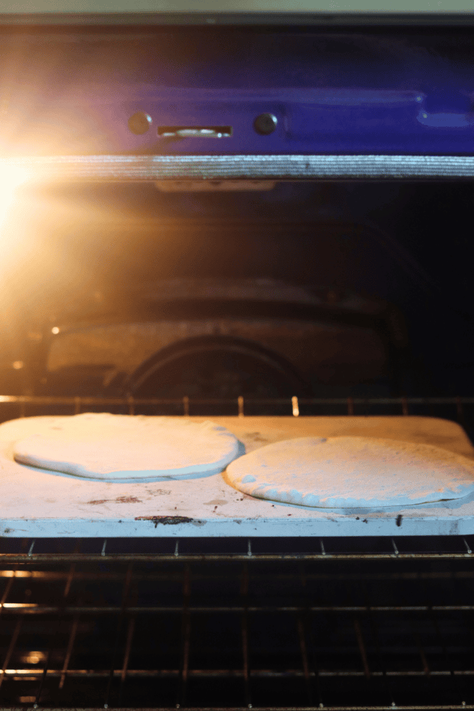 two pita bread dough left to bake