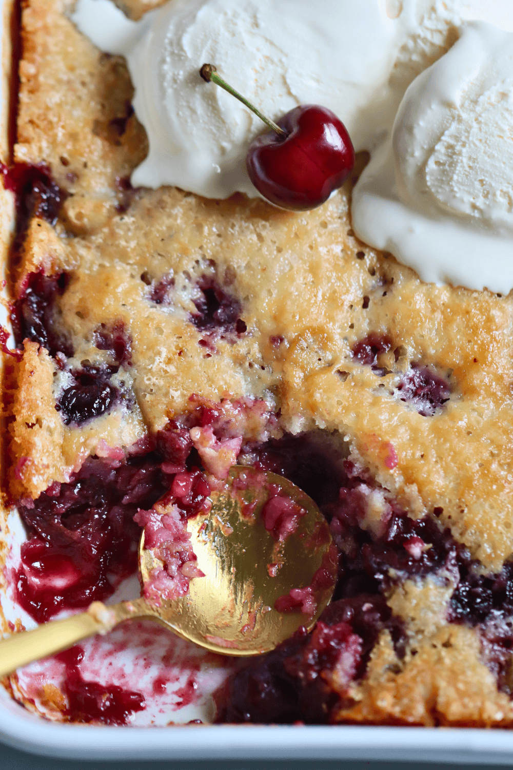 scooping out sourdough cherry cobbler