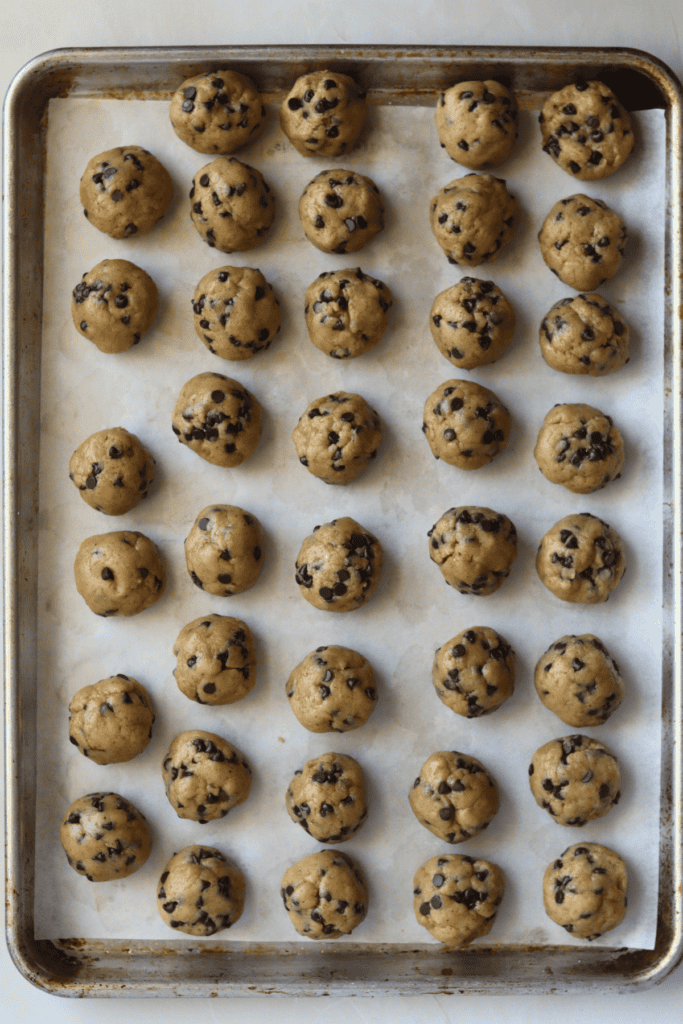 shaped dough with chocolate chips on a baking sheet