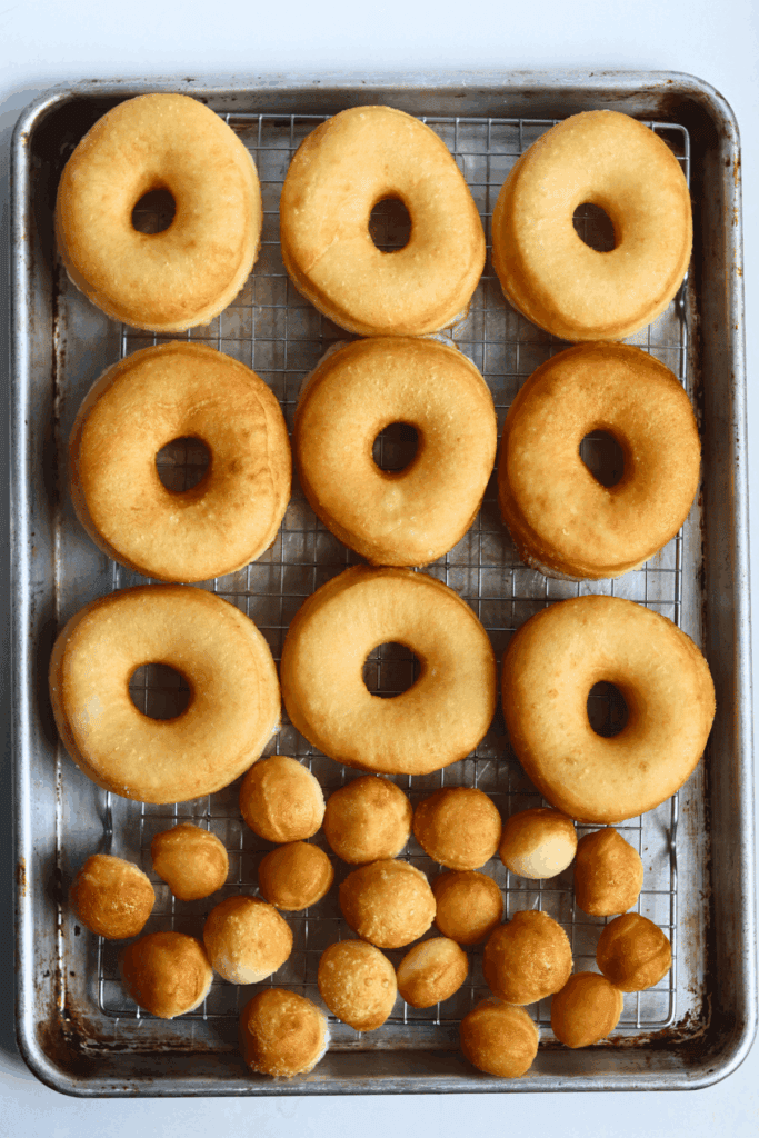 fried sourdough donuts on a wire rack