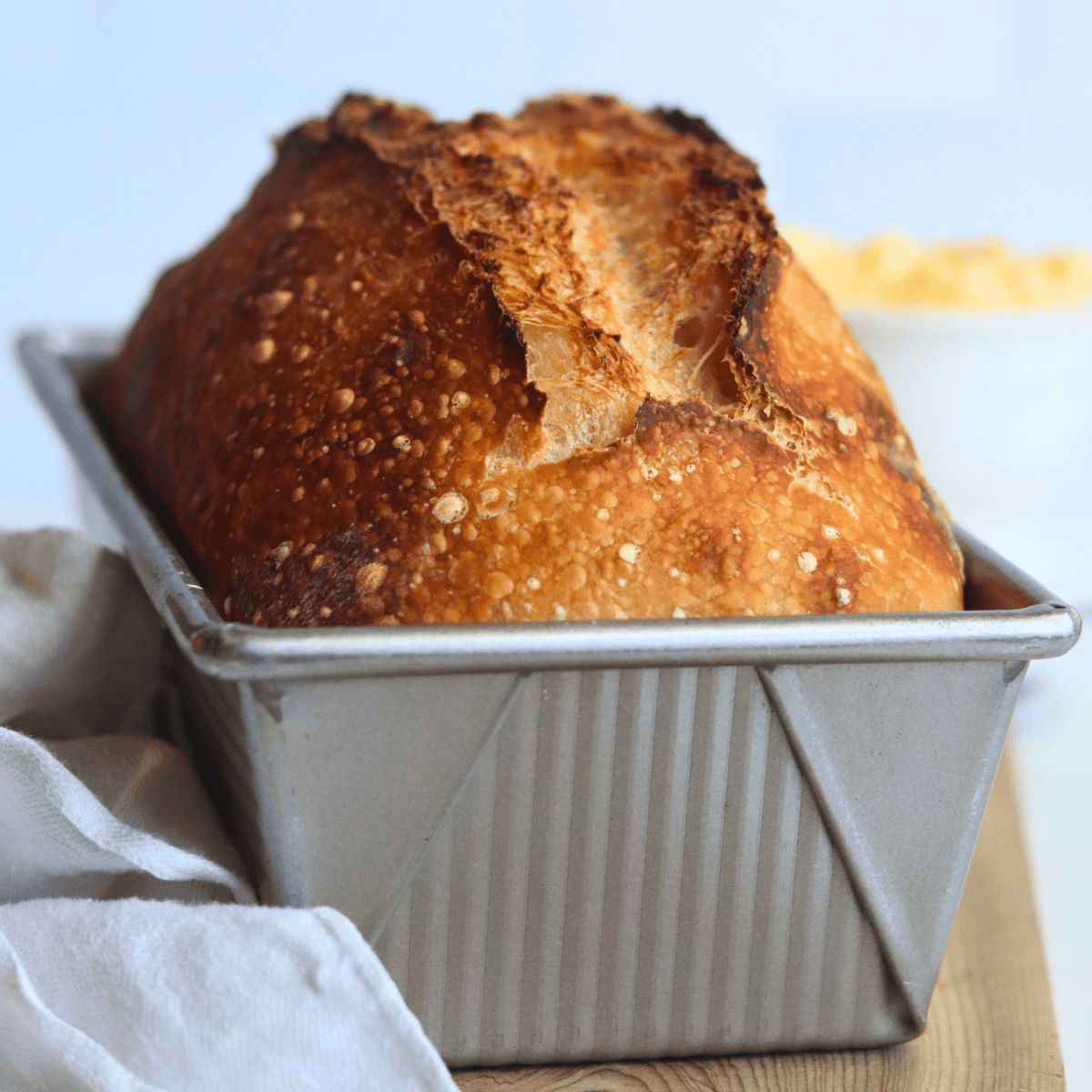 loaf of sourdough bread in a loaf pan