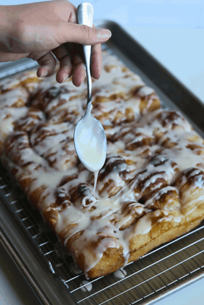sourdough cinnamon roll focaccia drizzled with vanilla glaze