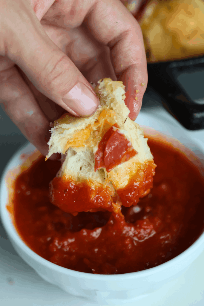 sourdough discard pizza pull apart rolls dipped into a sauce