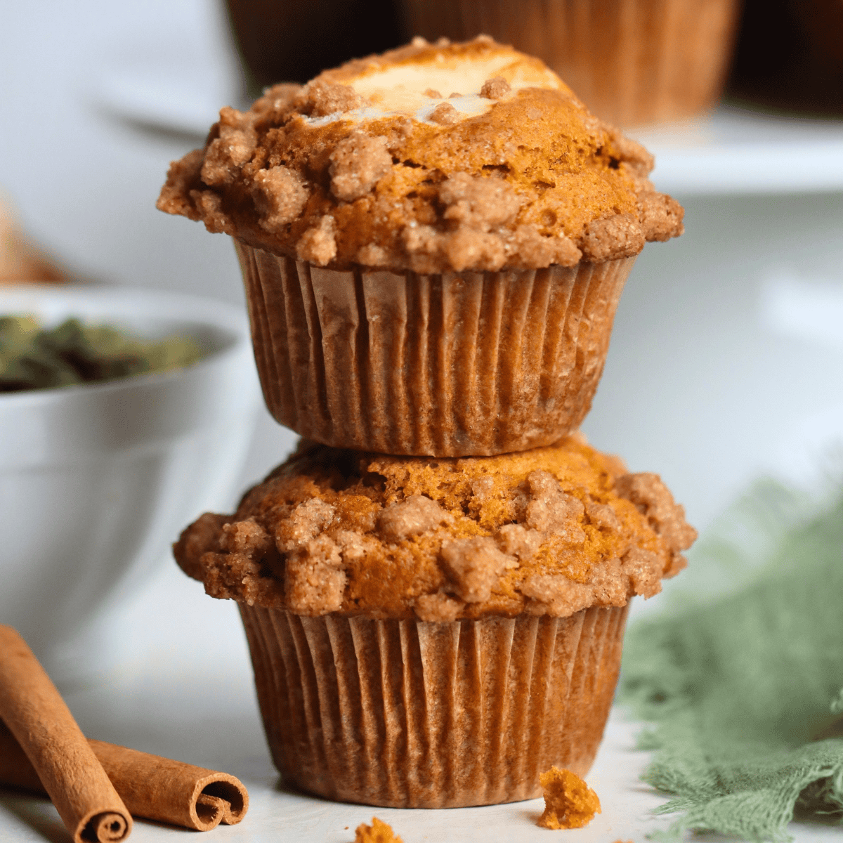 sourdough pumpkin cream cheese muffins stacked on top of one another
